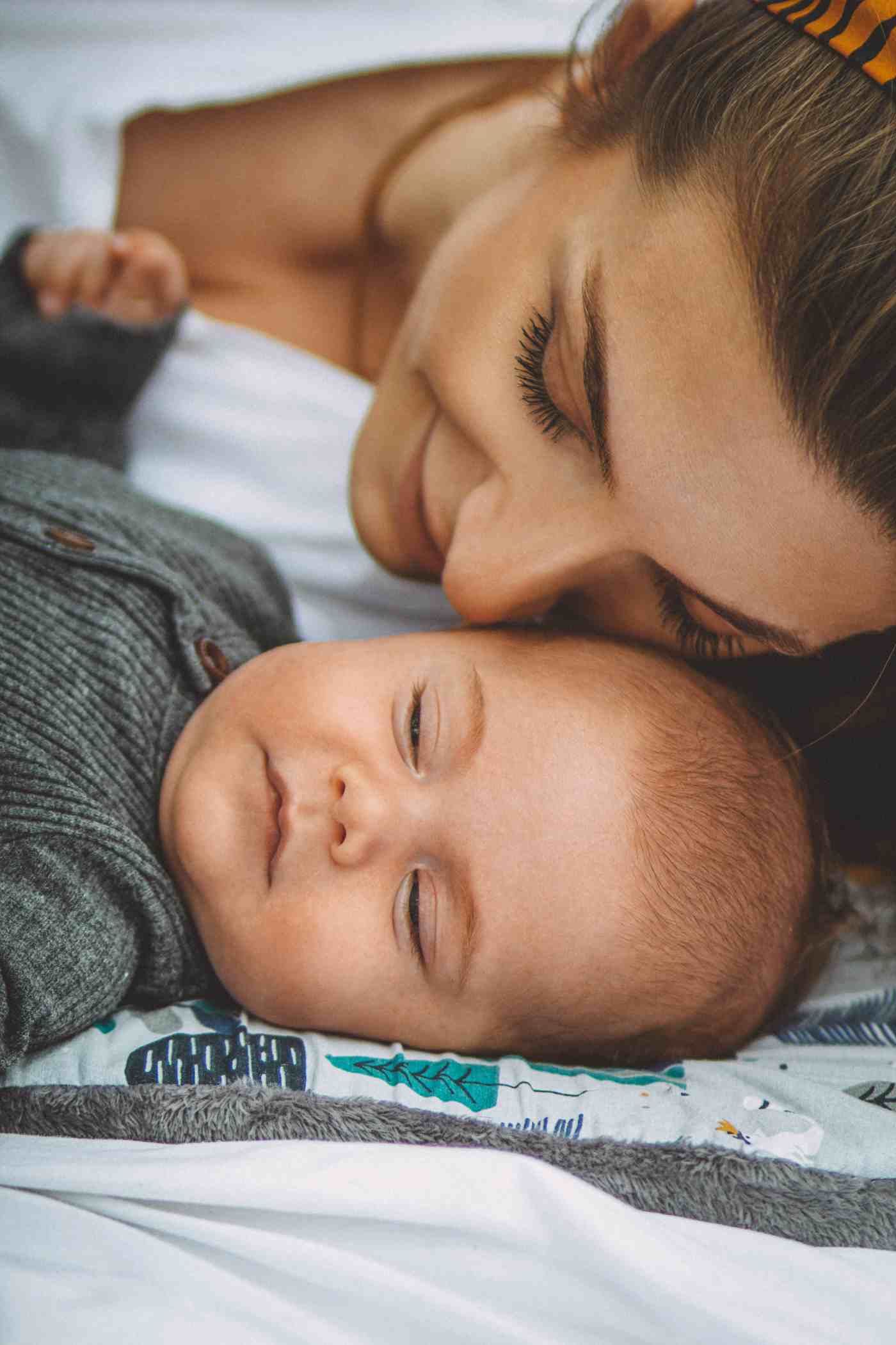 Mother resting with her sleeping baby girl