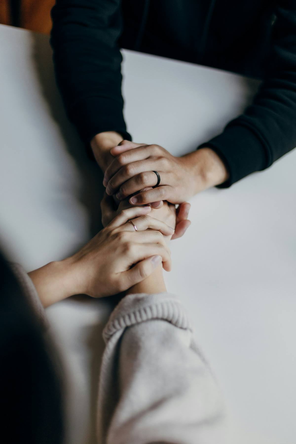 Engaged couple holding hands with rings