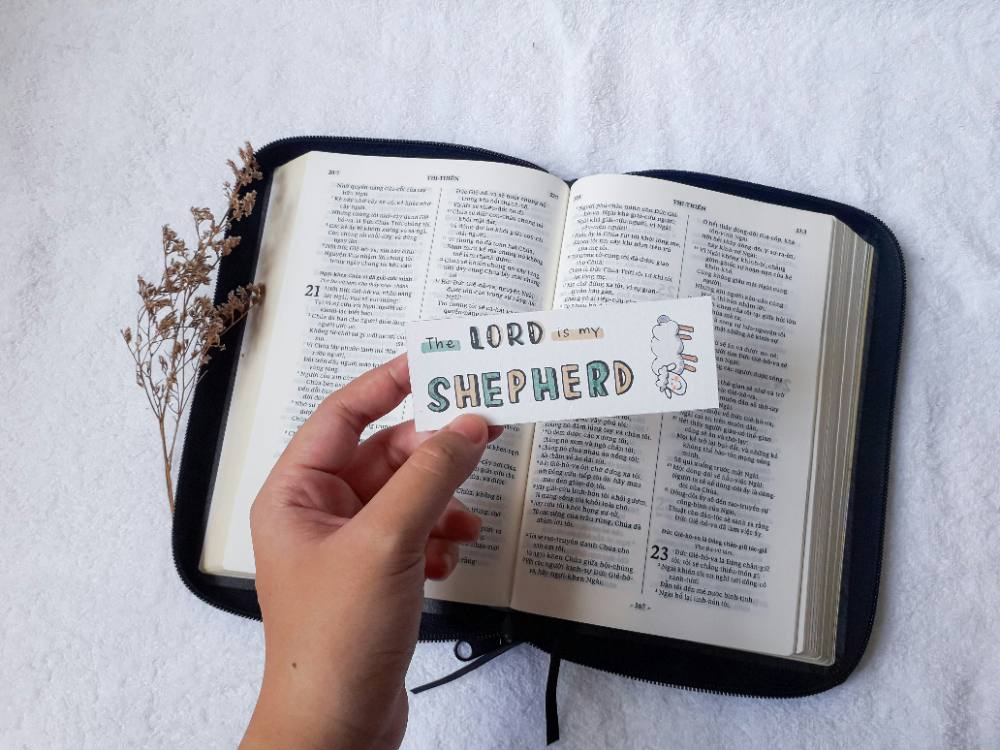 Handwritten self-love journal page held in hand outdoors